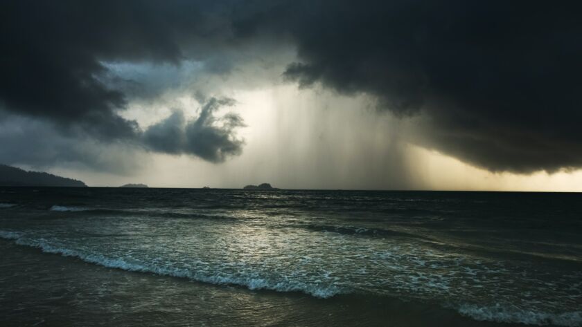 Dramatic seascape with storm and rain and dark clouds