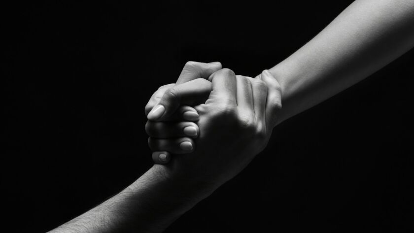 Unrecognizable woman hand helping man to stand up
